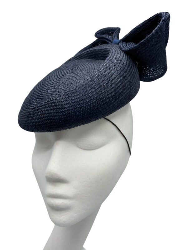 Stunning navy structured headpiece with bow detail to the back.